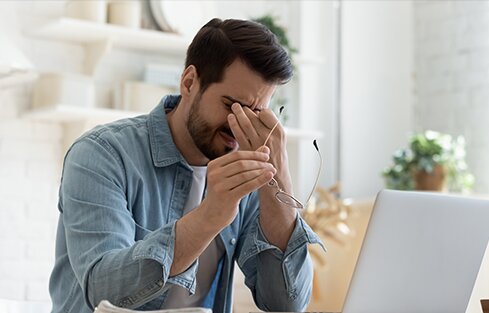 Man scratching eyes